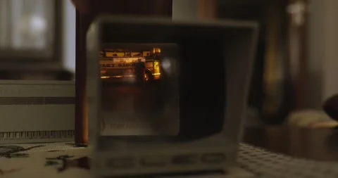 A hand inserts images of New York into a slide viewer Stock Footage 245425640