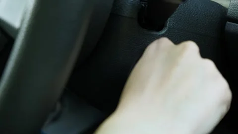 The hand inserts the key into the ignition of the car and starts it. Close-up Stock Footage 240561184