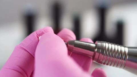 Hand inserts a milling cutter for removing gel polish into the manicure machine Stock Footage 196223353