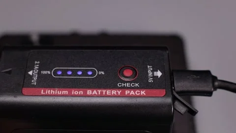 Hand inserts the plug of the charger cable into the battery close-up, macro Video stock 226829671