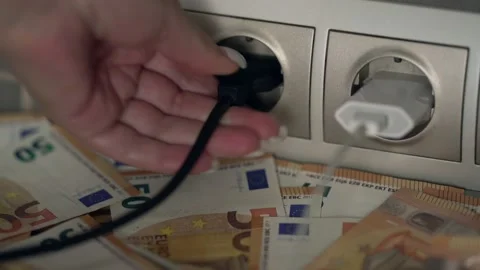 Hand inserts plug into socket to charge electronic device. Video stock 234786176