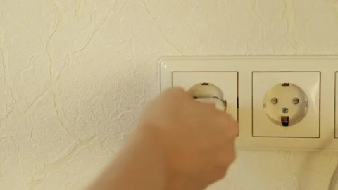 Hand inserts the plug into the socket Stock Footage 144489828