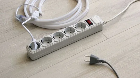 Hand inserts the plugs into the extension cord and turn on the neon strip Stock Footage 128228991
