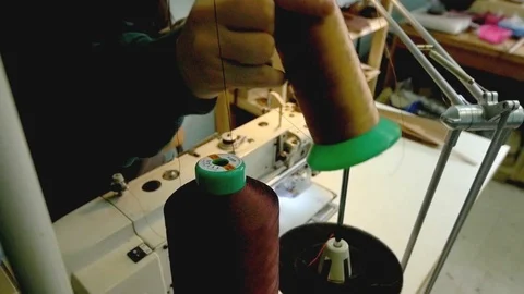 Hand inserts sewing thread on holder Stock Footage 118136135