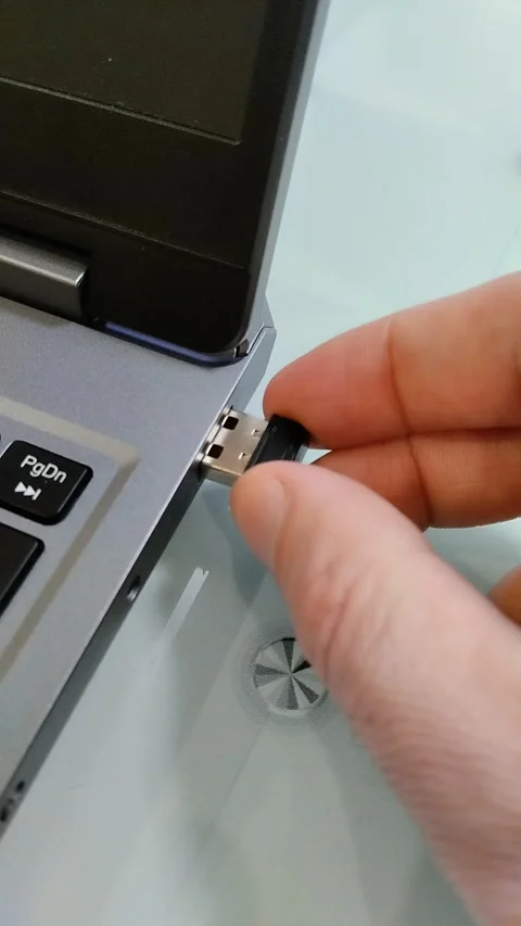 Hand inserts a small black USB receiver Stock Footage 331597285