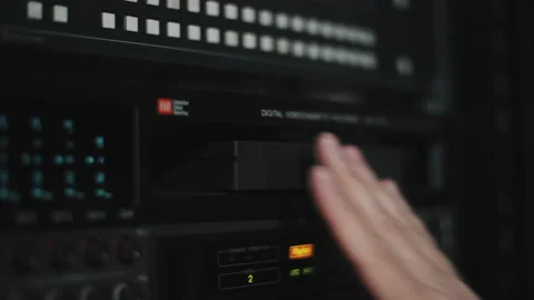 hand inserts a VHS cartridge into the VH... | Stock Video | Pond5