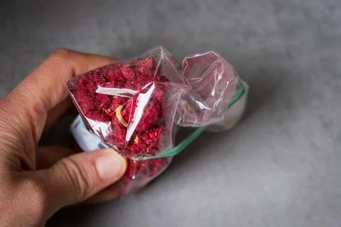 Hand inspecting dried fruit package with food moth larvae Stock Photos