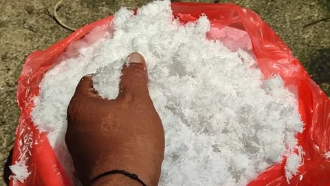 Hand Inspecting Fresh Grated Coconut Dregs in Red Plastic Bag Vídeos de archivo 336037423