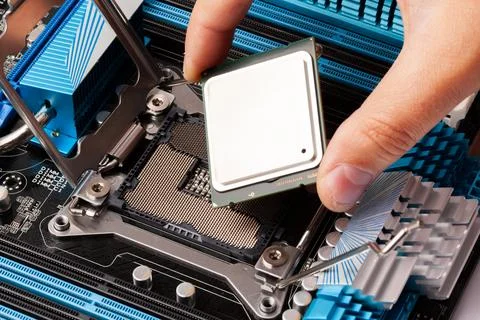 Hand Installing Processor Chip on Motherboard for Computer Upgrade Stock Photos