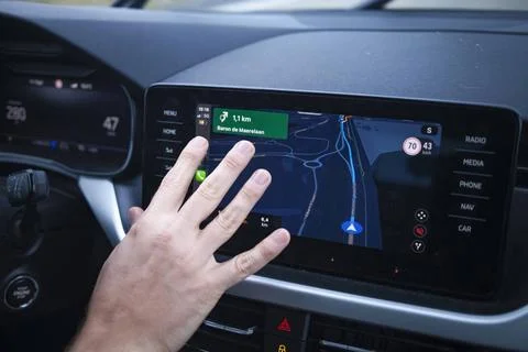 Hand interacting with a car s touchscreen navigation system showing a map ... Stock Photos