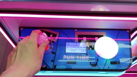 Hand Interacting with Neon-Lit Arcade Interface in a Futuristic Setting Stock Footage 309841190
