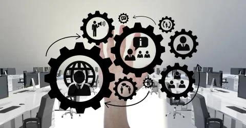 Hand interacting with people in cogs graphics against office background Foto stock