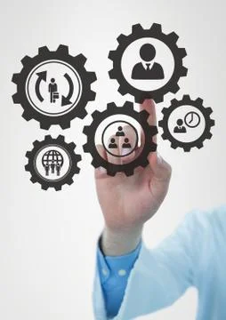 Hand interacting with people in cogs graphics against white background Stock Photos