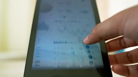 Hand Interacting with Tablet Displaying Graphs Stock Footage 317737515