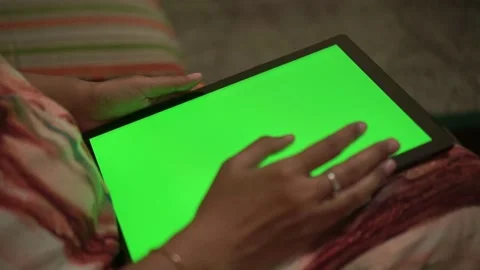 Hand interacting with tablet green screen. Digital device, touchscreen interface Stock Footage 331461781