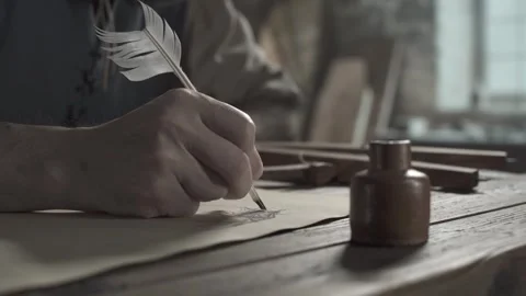 Hand of an inventor drawing a flying machine wing design with a quill pen Stock Footage 339631146