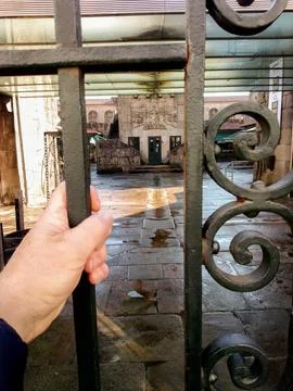 Hand on the iron gate Stock Photos