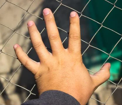 Hand on an iron grid Stock Photos