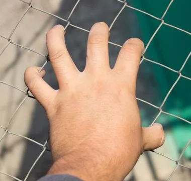 Hand on an iron grid Stock Photos