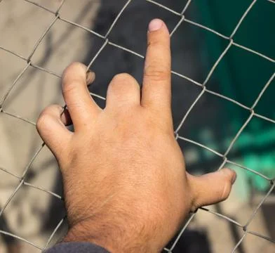 Hand on an iron grid Stock Photos