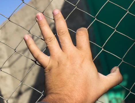 Hand on an iron grid Stock Photos