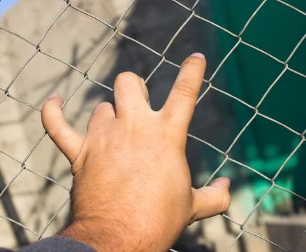 Hand on an iron grid Foto stock