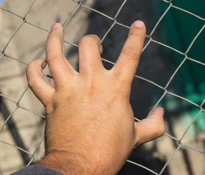 Hand on an iron grid Foto stock