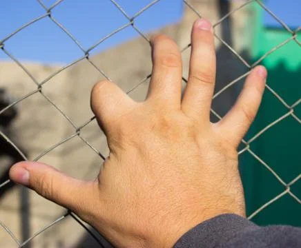 Hand on an iron grid Stock Photos