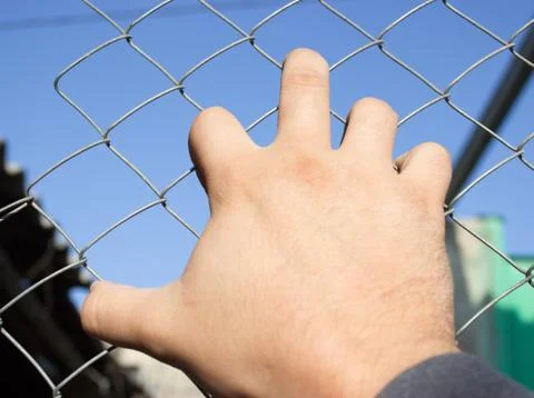 Hand on an iron grid Stock Photos