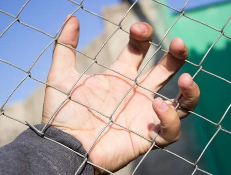 Hand on an iron grid Stock Photos