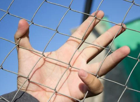 Hand on an iron grid Foto stock
