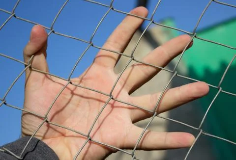 Hand on an iron grid Foto stock