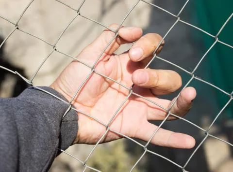 Hand on an iron grid Stock Photos