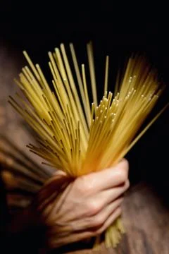 Hand with Italian spaghetti Stock Photos