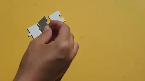 Hand join the piece of jigsaw puzzle to complete the line. Stock Footage 220413858