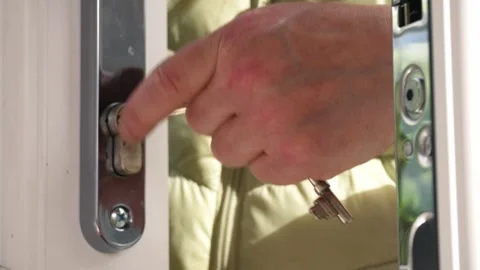 Hand with key in door Stock Footage 310942508