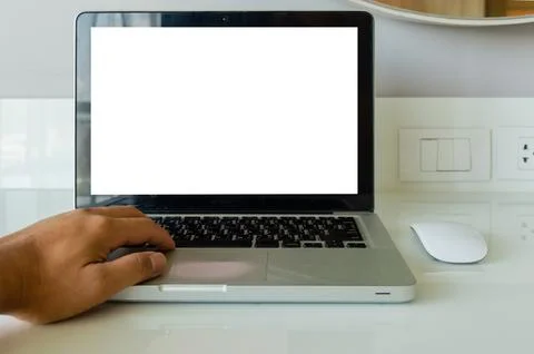 Hand on keyboard computer laptop mock up and mouse white blank screen for a.. Stock Photos
