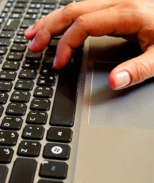 Hand in keyboard Stock Photos