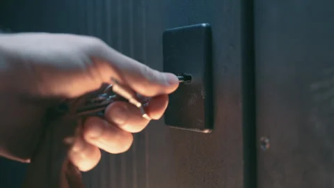 Hand with Keychain Unlocking Modern Door at Sunset. Home Security Access Concept Stock Footage 345763466