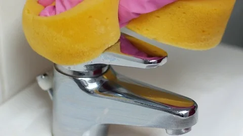 Hand in kitchen glows cleaning a bathroom tap Stock Footage 72787817