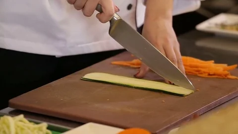 Hand with a knife cut zucchini for vegetable pasta Stock Footage 74716128