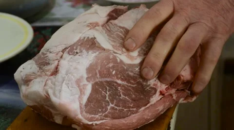 Hand With With a Knife Cuts a Large Piece of Meat Lying on a Board Stock Footage 61521065