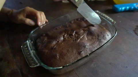Hand With Knife Cutting Through Freshly Baked Brownie Cake [Slow Motion] Stock Footage 89606151
