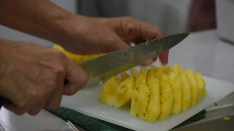 Hand with knife slicing pineapple. Stock Footage 233270377