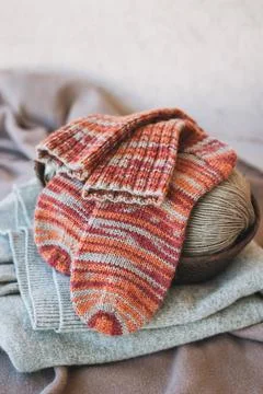 Hand knitted socks with needles and yarn ball. Concept for handmade and hygge Stock Photos