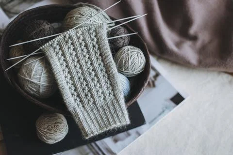 Hand knitted socks with needles and yarn ball in a basket. Concept for hand.. Stock Photos