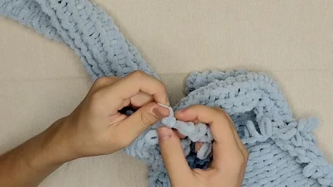 Hand knitting blue plush loop yarn scarf without needles close up Stock-Footage 346305165