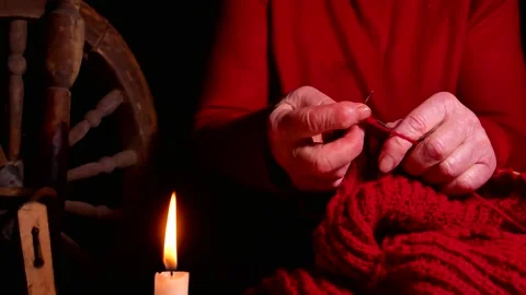 Hand knitting by candlelight in the dark. Stock Footage 144130094
