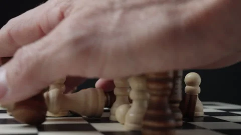 Hand knocking down chess pieces in dramatic collapse concept 스톡 동영상 329588315