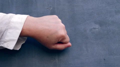 Hand knocking on gray background Stock Footage 214026200